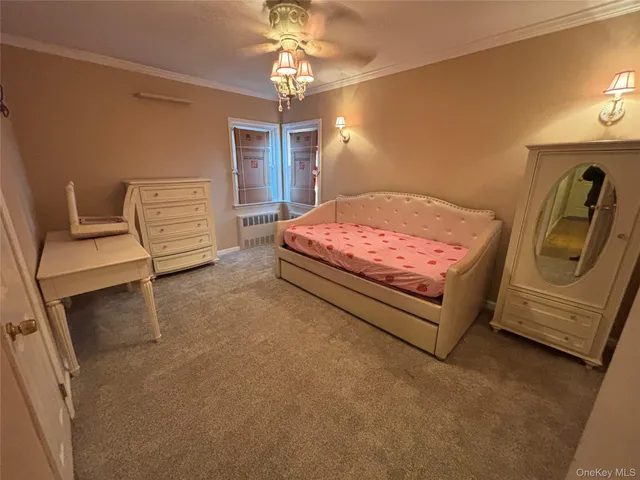 a spacious bedroom with a bed and a chandelier