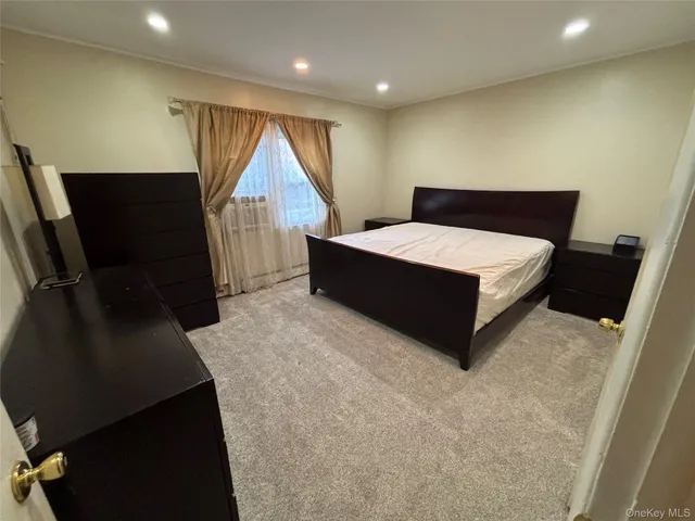 a room with a bed and a flat screen tv