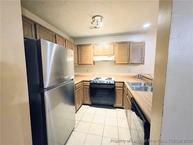 a kitchen with a refrigerator sink and stove