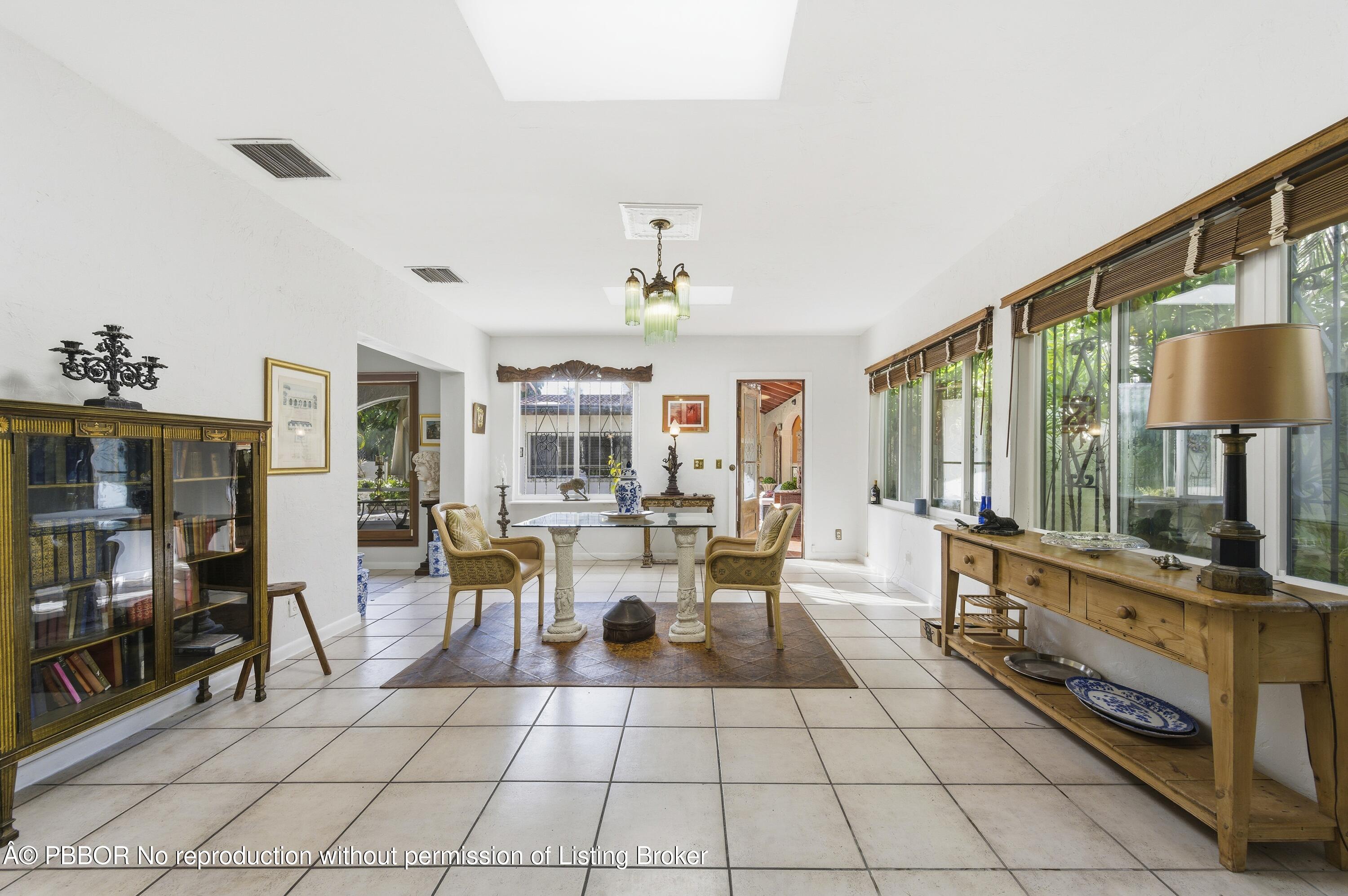 281 Granada Road West Palm Beach, FL 33401 - Photo 13 of 19 a living room with furniture a flat screen tv and a floor to ceiling window