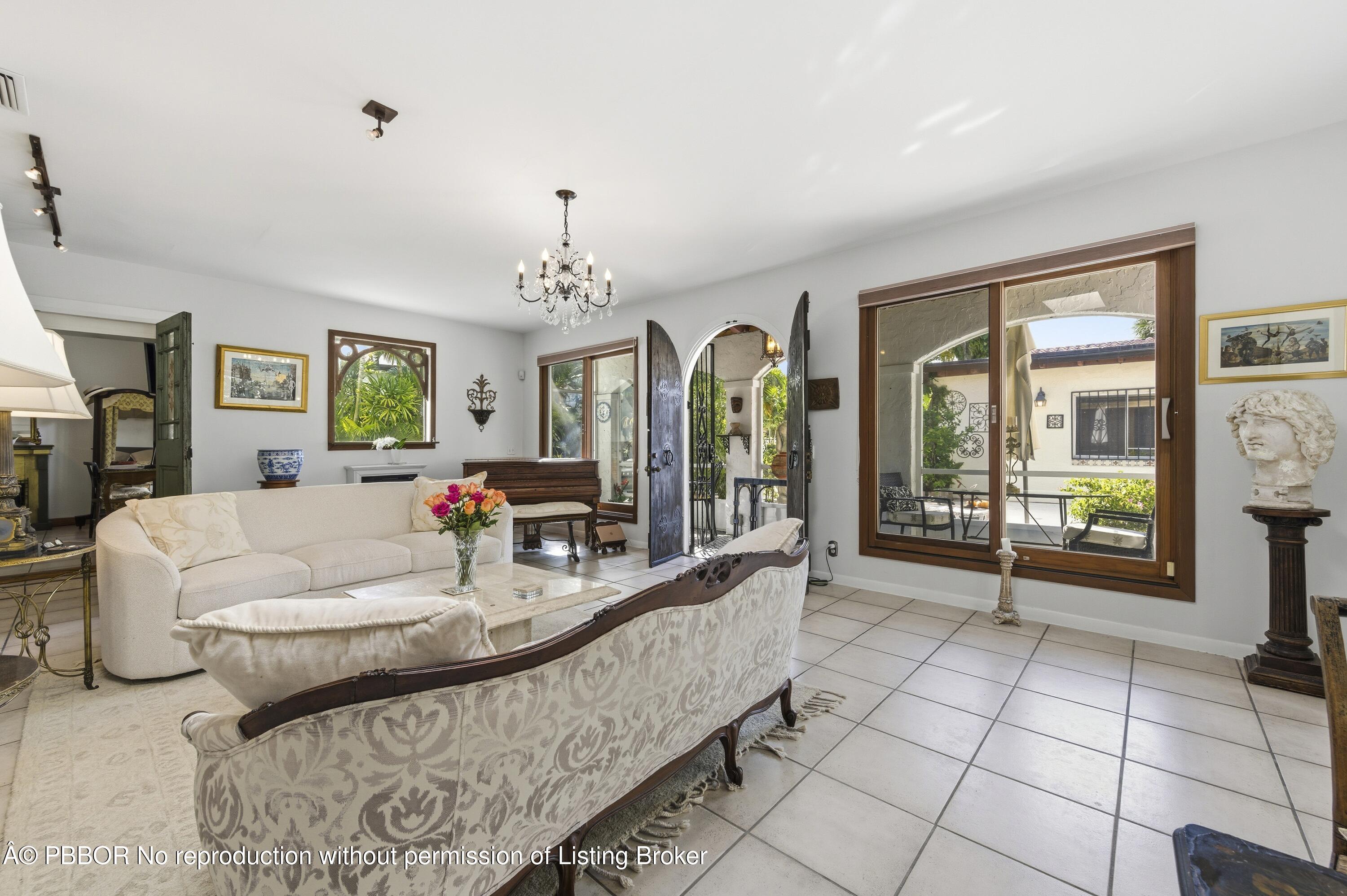281 Granada Road West Palm Beach, FL 33401 - Photo 15 of 19 a living room with fireplace furniture and a floor to ceiling window