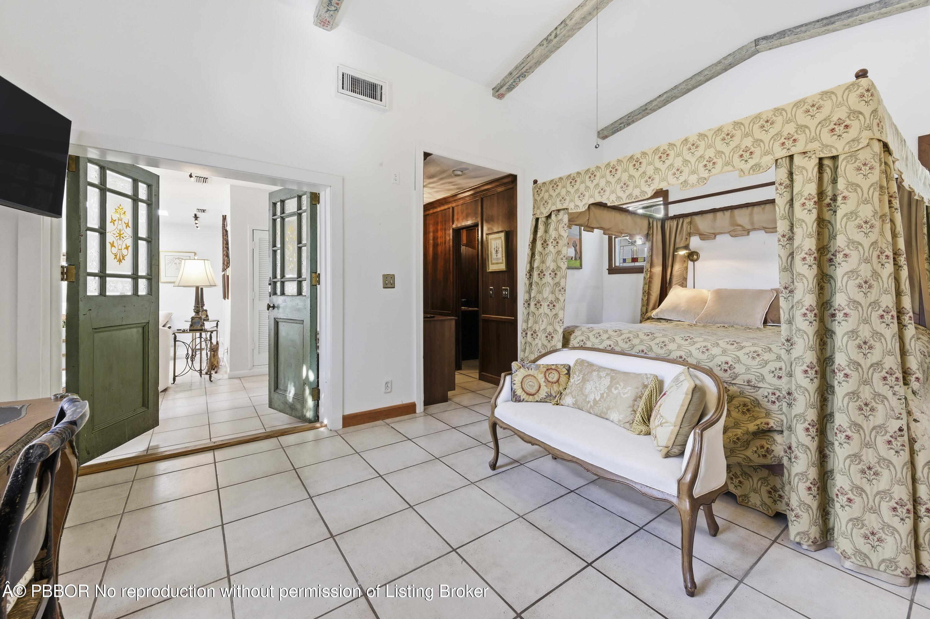 281 Granada Road West Palm Beach, FL 33401 - Photo 17 of 19 a spacious bedroom with a bed and walk in closet