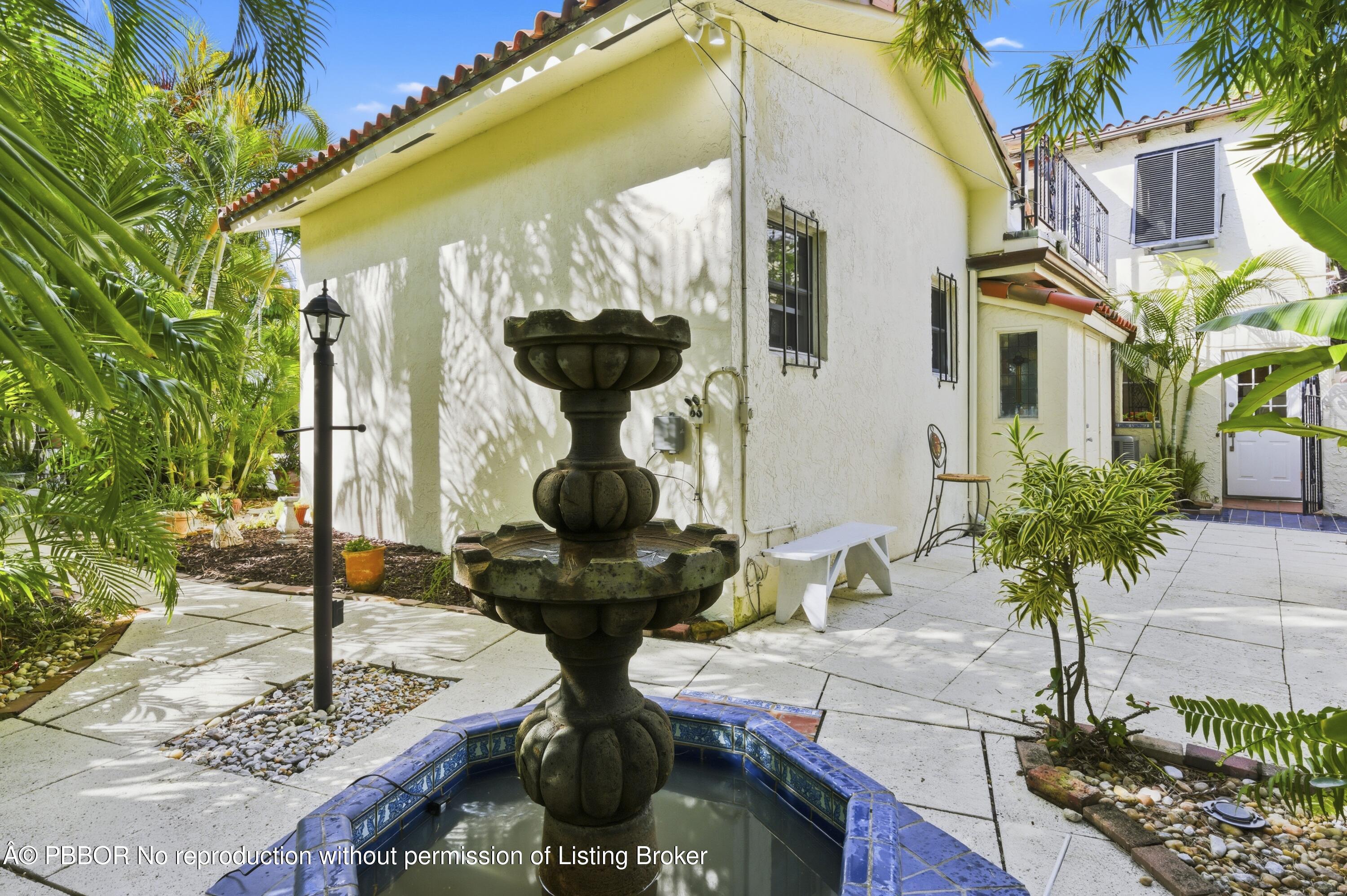 281 Granada Road West Palm Beach, FL 33401 - Photo 3 of 19 a front view of a house with fountain