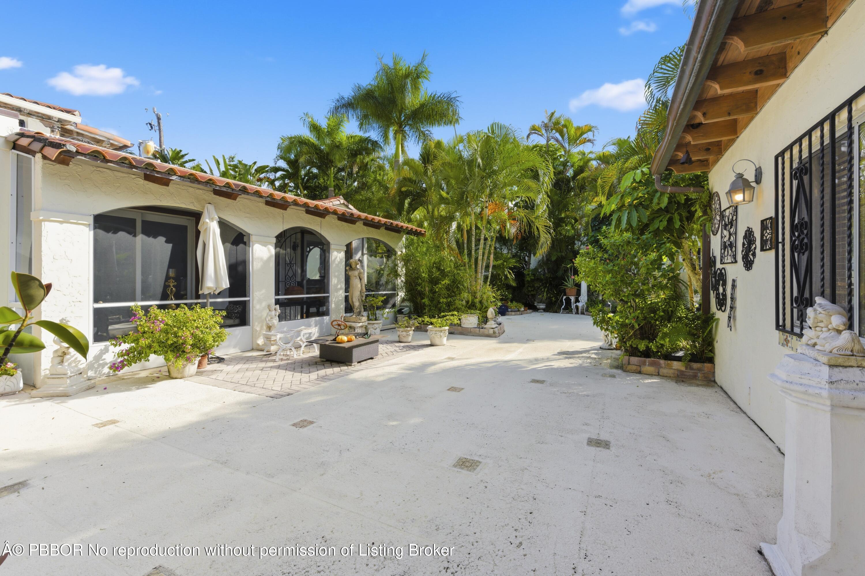 281 Granada Road West Palm Beach, FL 33401 - Photo 5 of 19 a view of a house with backyard and sitting area
