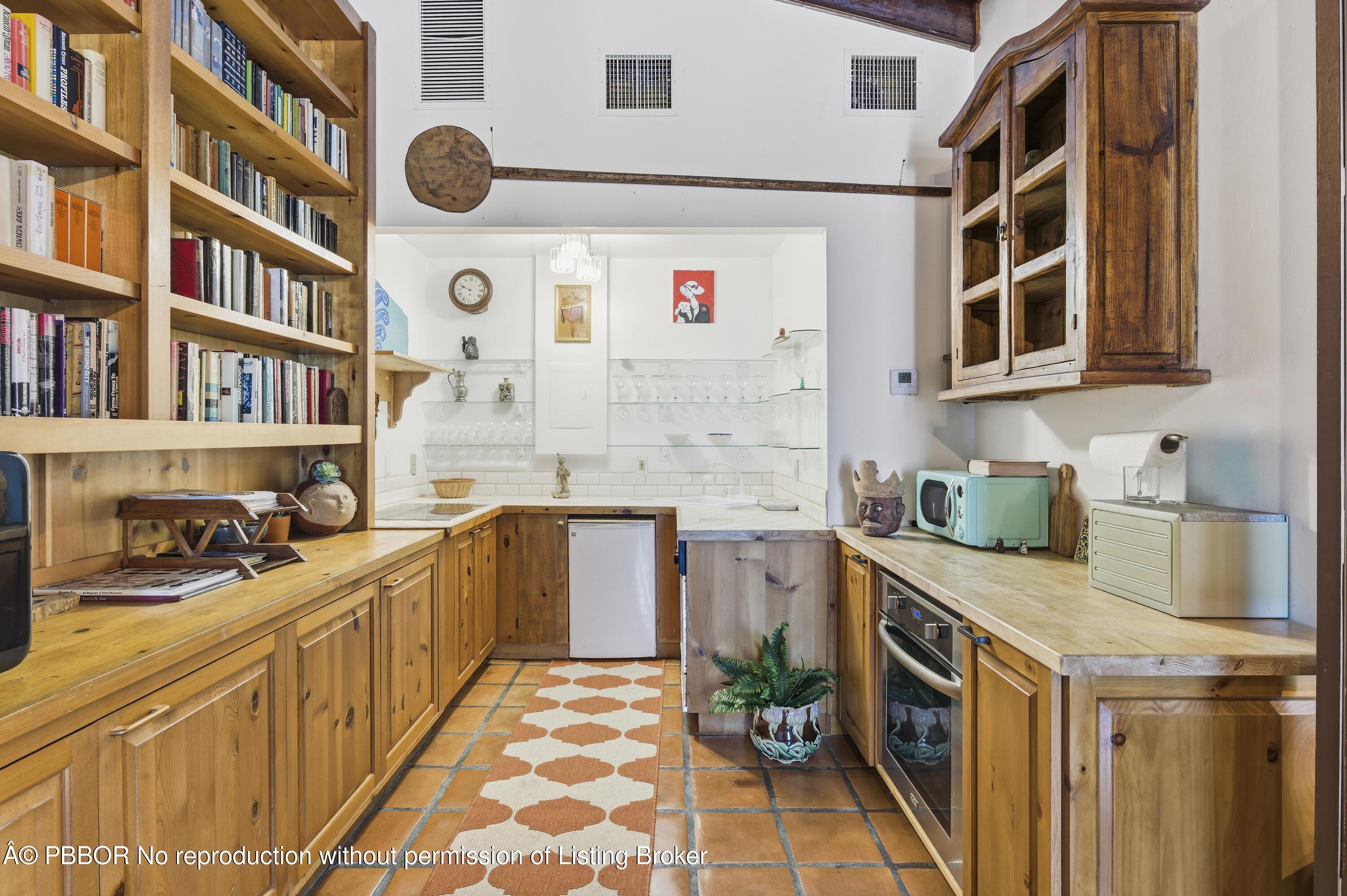 281 Granada Road West Palm Beach, FL 33401 - Photo 9 of 19 a kitchen with stainless steel appliances a stove a sink and a refrigerator