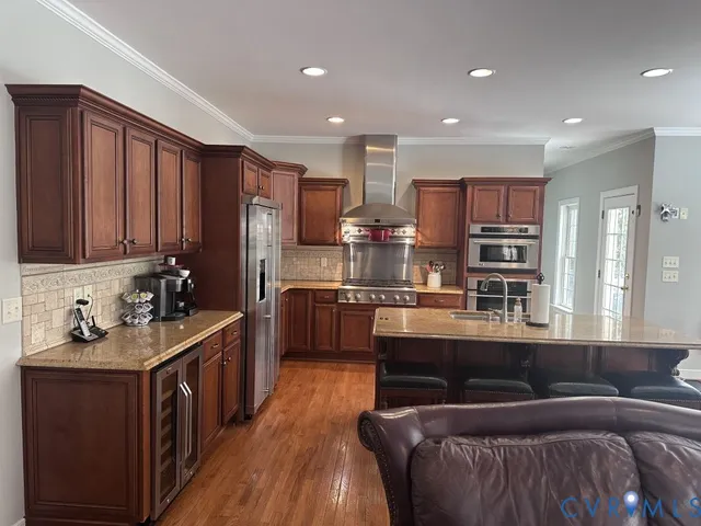 a living room with furniture kitchen and a large window