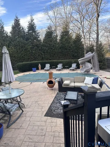 a view of backyard with seating space and trees