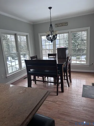 a spacious bathroom with a granite countertop sink a toilet a mirror and shower