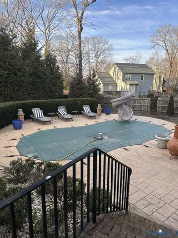 a view of a house with a yard chairs and fire pit