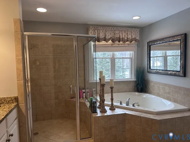 a view of a house with a small yard and large tree