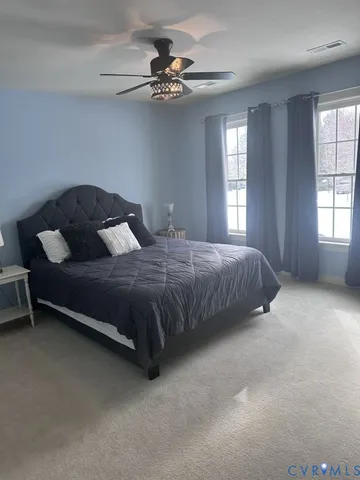 a bathroom with a granite countertop sink a toilet and a mirror