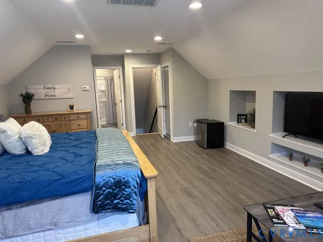 a view of walk in closet with clothes