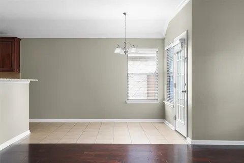a spacious bedroom with a bed and a chandelier