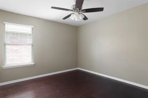 a bathroom with a granite countertop bathtub sink vanity mirror and toilet