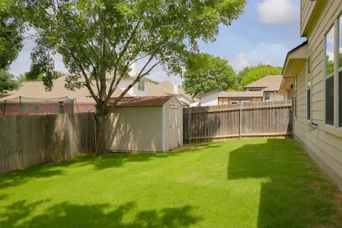 a view of residential houses with outdoor space and street view