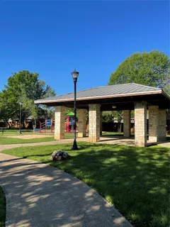 a view of a park with large trees