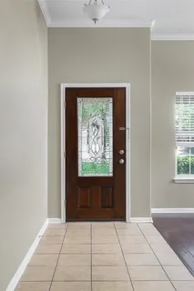 a view of a dining room with furniture a potted plant and wooden floor