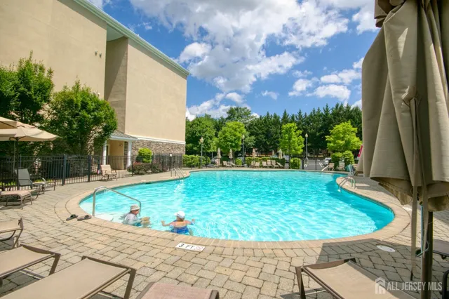 a view of a patio with table and chairs under an umbrella