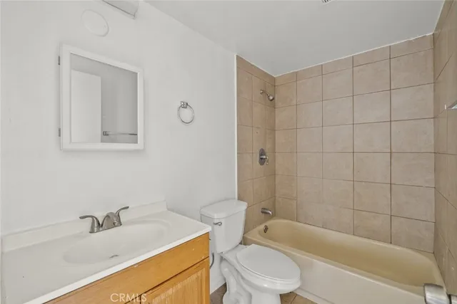 a bathroom with a sink a toilet and bathtub