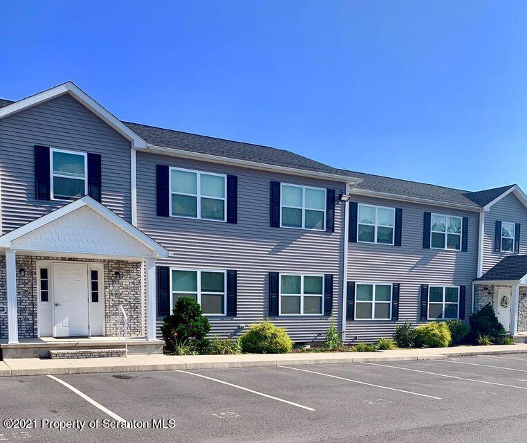 905 Ash Street Moosic, PA 18507 - Photo 1 of 7 a front view of a house with a garden