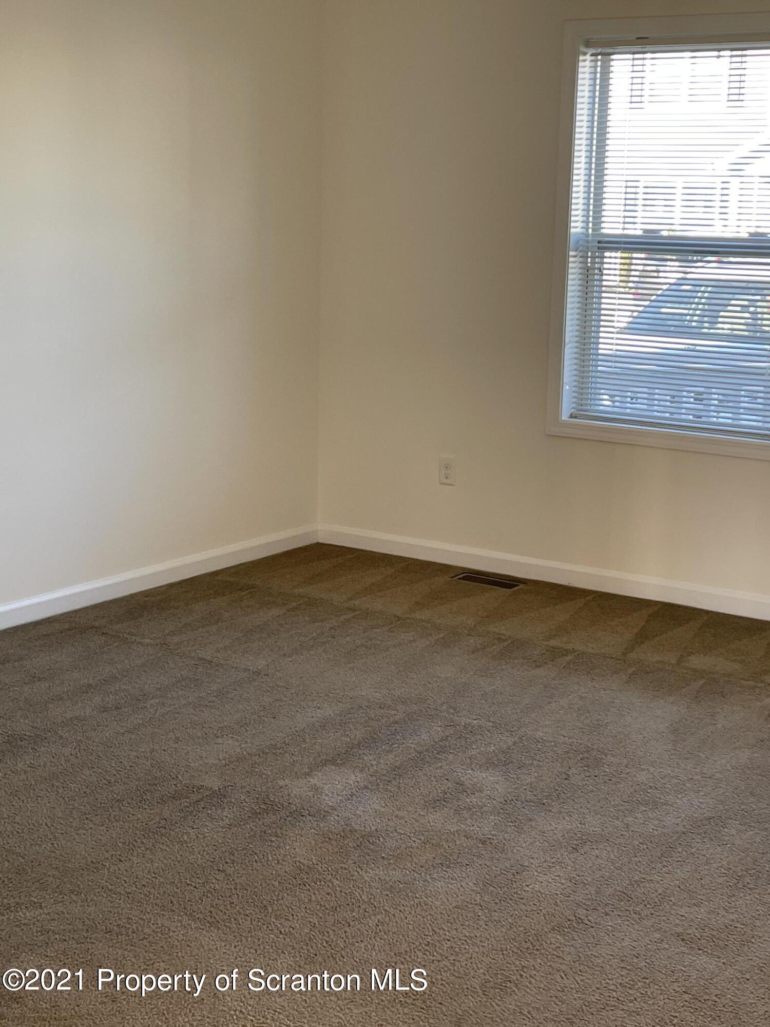 905 Ash Street Moosic, PA 18507 - Photo 4 of 7 an empty room with a window