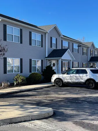 a view of a car parked in front of a brick house