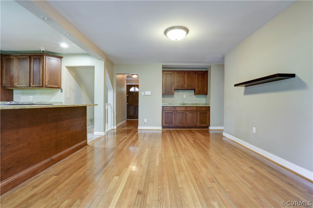 7741 Marilea Road Richmond, VA 23225 - Photo 11 of 44 wooden floor in an empty room with a kitchen