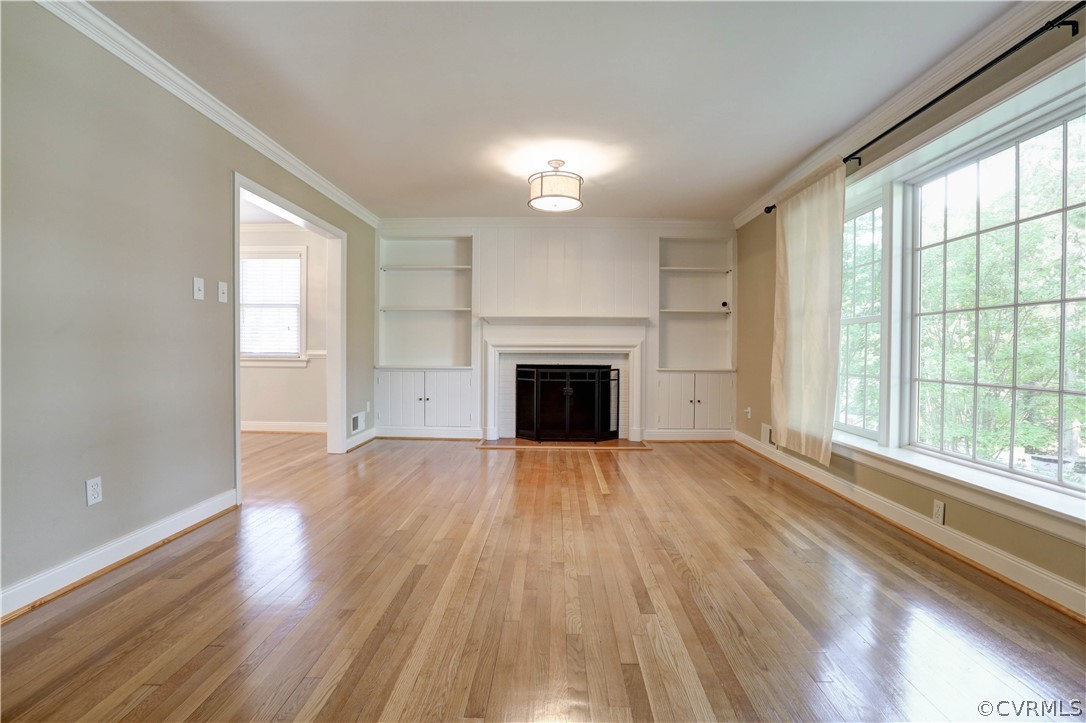 7741 Marilea Road Richmond, VA 23225 - Photo 17 of 44 an empty room with wooden floor fireplace and windows