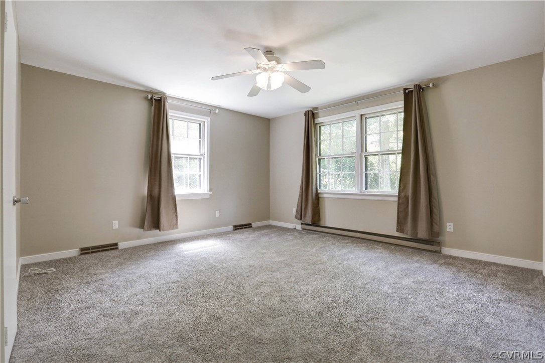 7741 Marilea Road Richmond, VA 23225 - Photo 20 of 44 an empty room with windows and ceiling fan