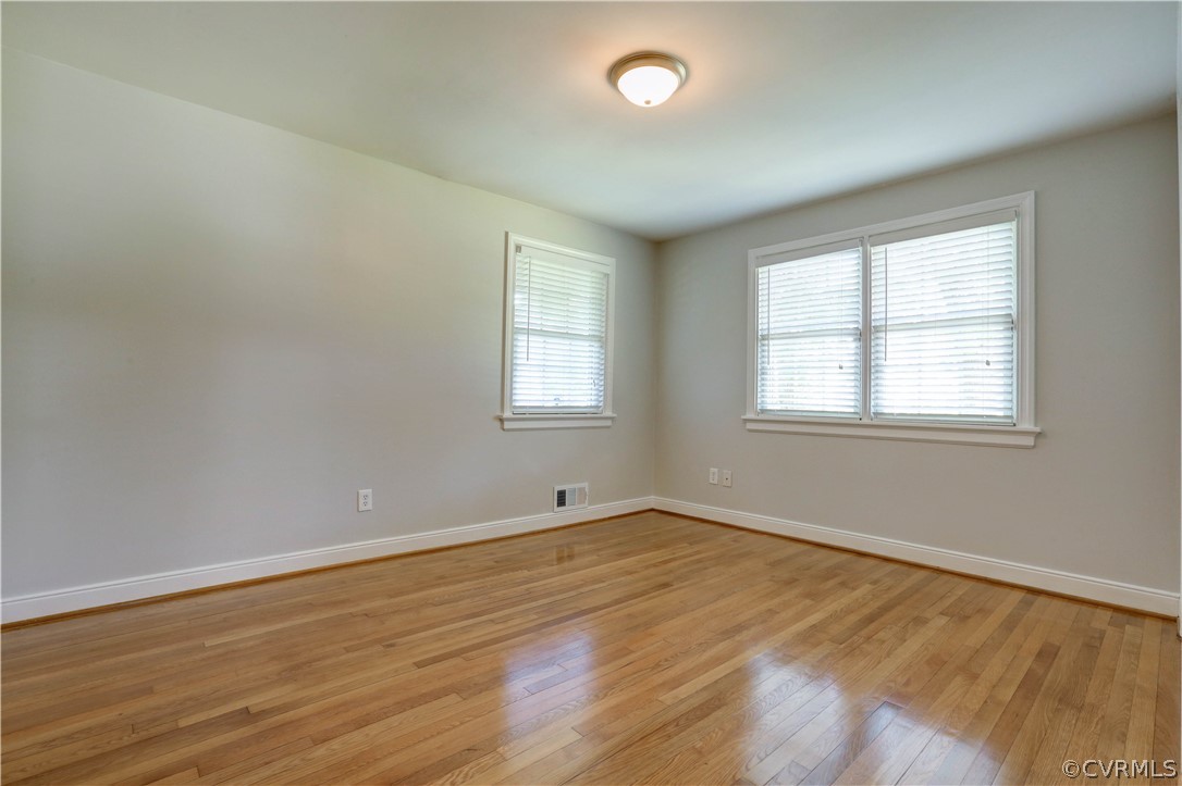7741 Marilea Road Richmond, VA 23225 - Photo 29 of 44 an empty room with wooden floor and windows