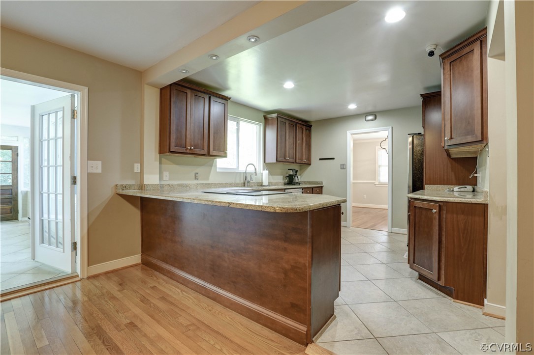 7741 Marilea Road Richmond, VA 23225 - Photo 6 of 44 a kitchen with kitchen island granite countertop wooden cabinets a refrigerator and a sink