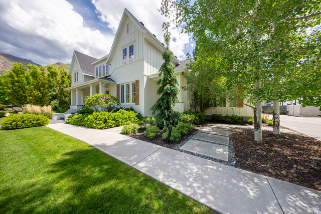 630 East Center Street Alpine, UT 84004 - Photo 111 of 115 White-sided residence featuring a covered porch with columns, a prominent gabled roofline, and wood shutters