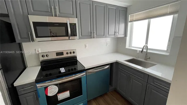 a kitchen with a stove microwave and sink