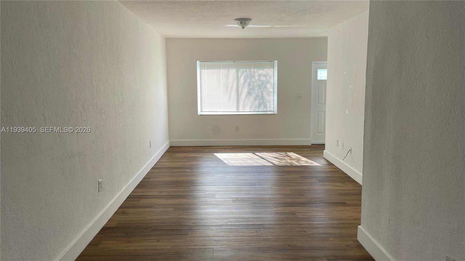 209 Northwest 84rd Street, Unit 209 Miami, FL 33150 - Photo 4 of 14 a view of empty room with wooden floor