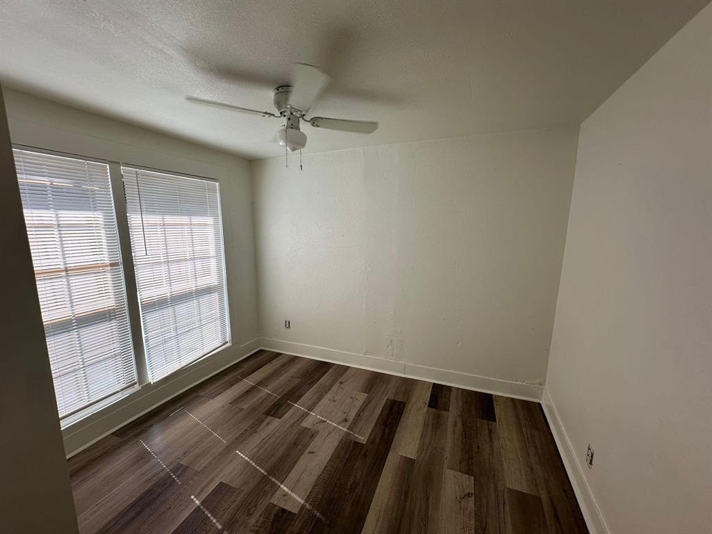 2206 Rockefeller Boulevard Dallas, TX 75203 - Photo 7 of 8 wooden floor in an empty room