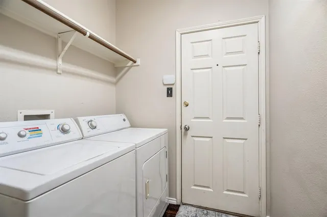 a view of storage and utility room with washer and dryer