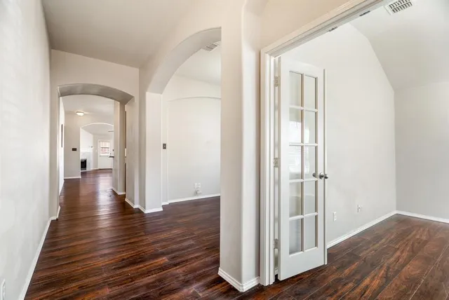 a view of a hallway with wooden floor