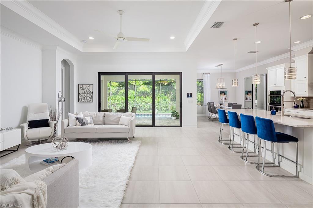 1423 Mockingbird Drive Naples, FL 34120 - Photo 12 of 32 a living room with furniture and a large window