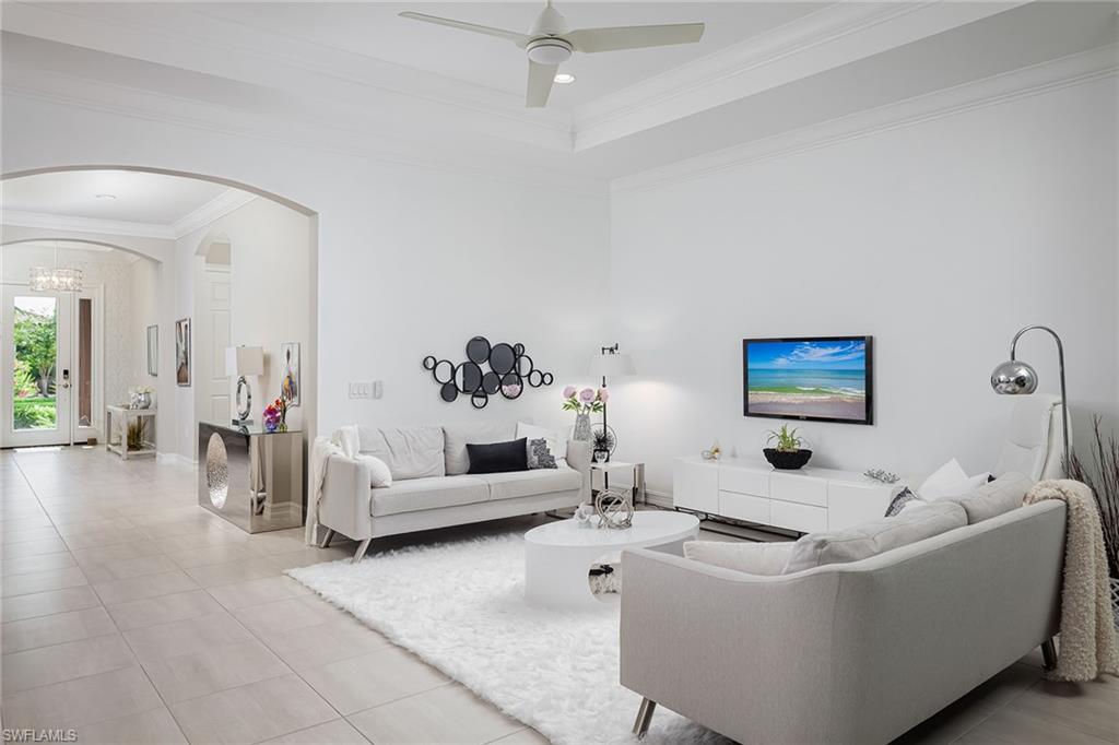 1423 Mockingbird Drive Naples, FL 34120 - Photo 14 of 32 a living room with furniture and a chandelier