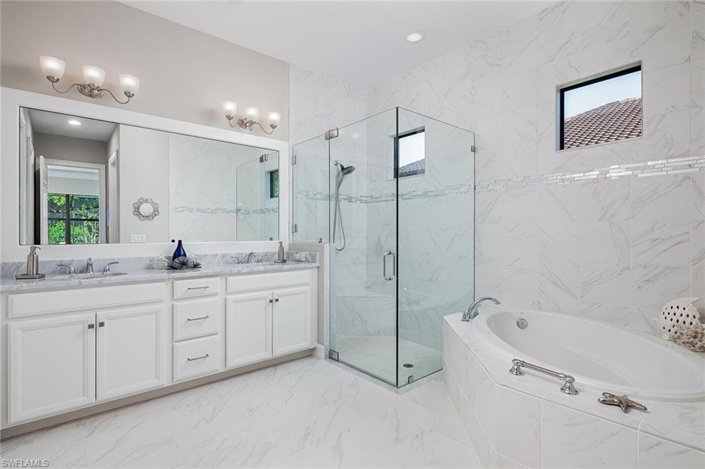 1423 Mockingbird Drive Naples, FL 34120 - Photo 17 of 32 a bathroom with a granite countertop sink a toilet a mirror and shower