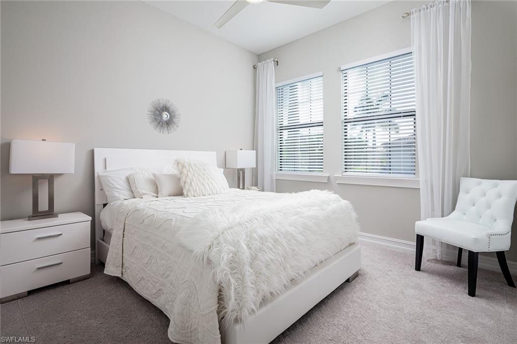 1423 Mockingbird Drive Naples, FL 34120 - Photo 18 of 32 a bedroom with a bed chair and a window