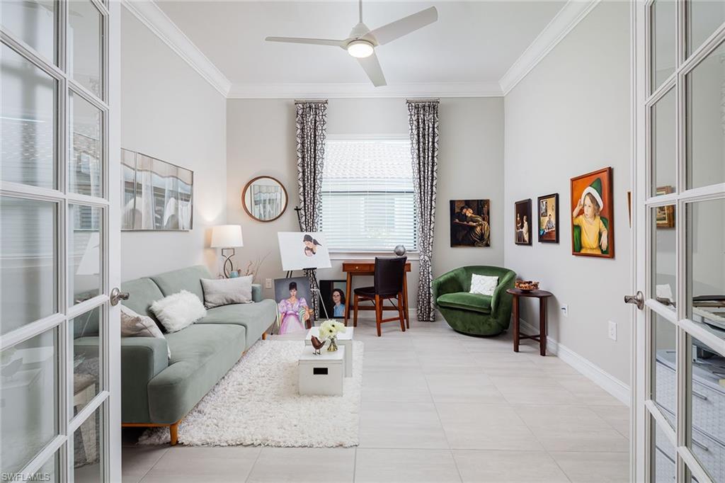 1423 Mockingbird Drive Naples, FL 34120 - Photo 20 of 32 a living room with furniture and a flat screen tv