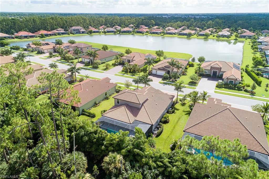 1423 Mockingbird Drive Naples, FL 34120 - Photo 2 of 32 an aerial view of a house with a lake view