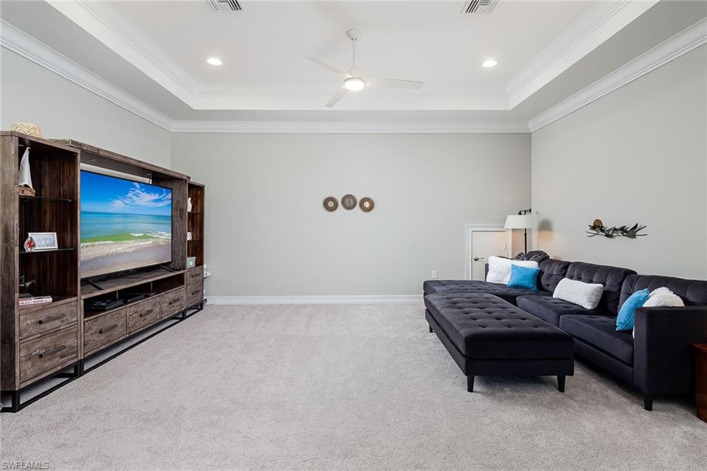 1423 Mockingbird Drive Naples, FL 34120 - Photo 23 of 32 a living room with furniture and a flat screen tv