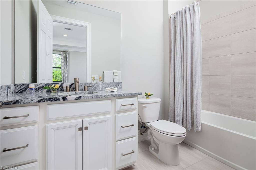 1423 Mockingbird Drive Naples, FL 34120 - Photo 25 of 32 a bathroom with a sink a toilet a mirror and shower