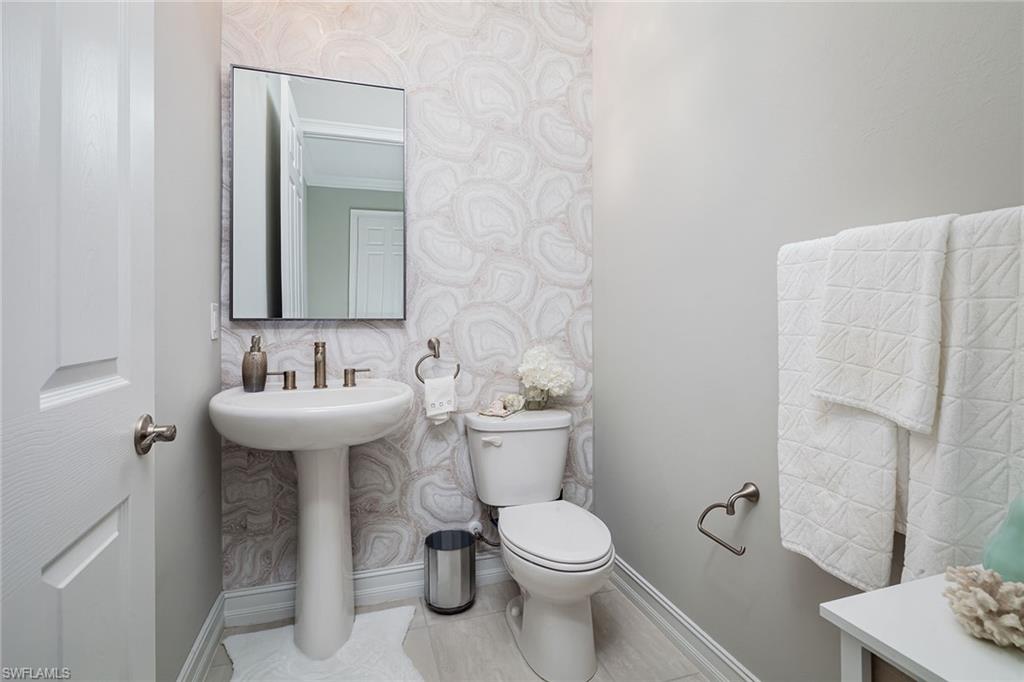 1423 Mockingbird Drive Naples, FL 34120 - Photo 27 of 32 a bathroom with a sink toilet and a mirror