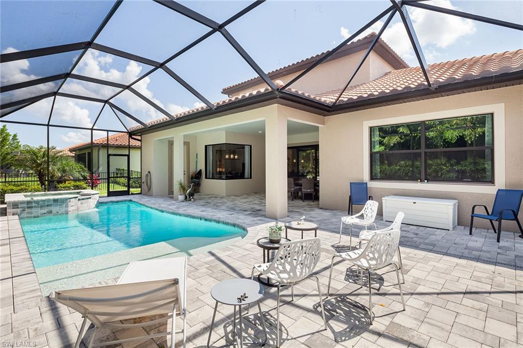 1423 Mockingbird Drive Naples, FL 34120 - Photo 31 of 32 a view of a patio with a dining table and chairs
