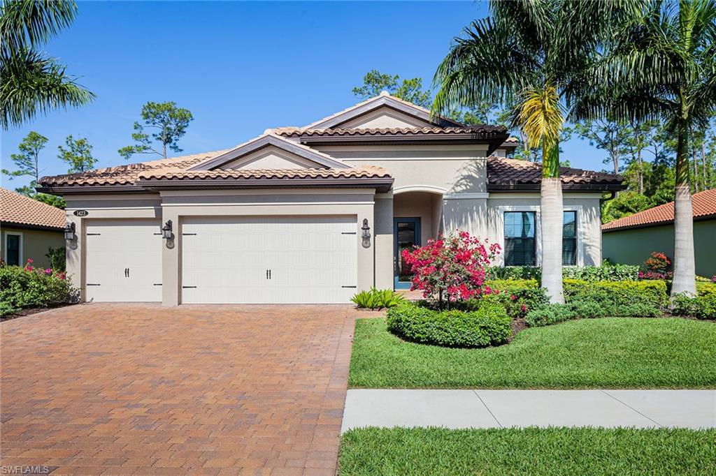 1423 Mockingbird Drive Naples, FL 34120 - Photo 32 of 32 a front view of a house with a garden and plants