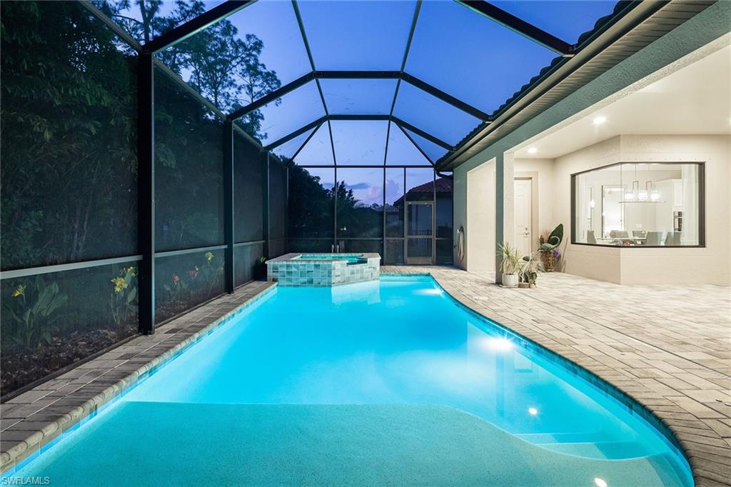 1423 Mockingbird Drive Naples, FL 34120 - Photo 6 of 32 a swimming pool with a outdoor seating