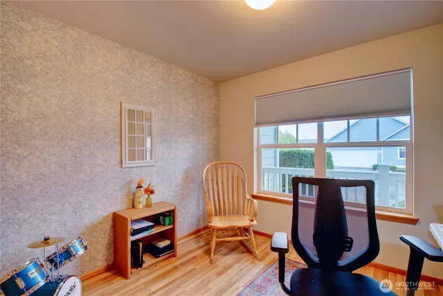 a view of a room with furniture and wooden floor